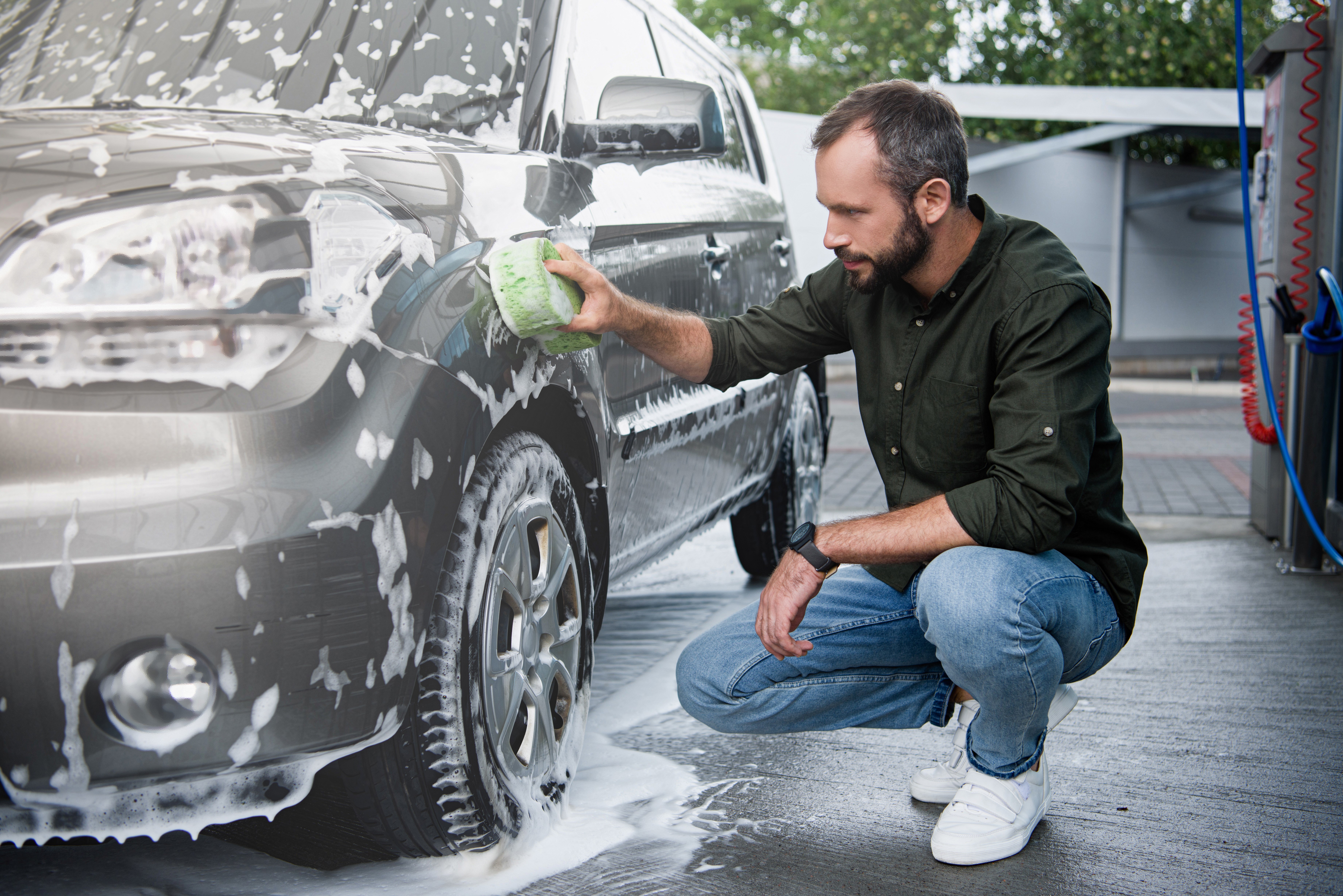 Guy Cleaning a Car with a Armor All Sponge